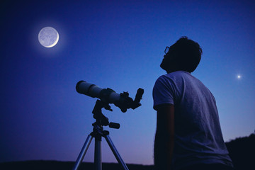 Astronomer with a telescope watching at the stars and Moon. My astronomy work. - obrazy, fototapety, plakaty