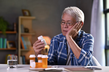Asian senior man  with his medicine bottles