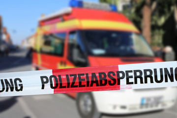 Polizeiabsperrung mit Krankenwagen im Hintergrund