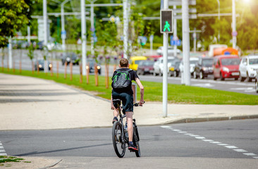 Fototapeta na wymiar Cyclist ride on the bike path in the city