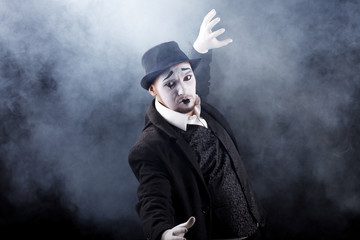 mime shows theatrical emotions on black background