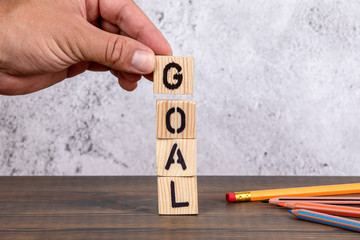 Goal. Wooden letters and pencils on the office desk