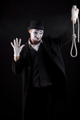 mime shows theatrical emotions on black background