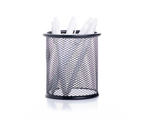 White pens in stationery stand on white background isolation