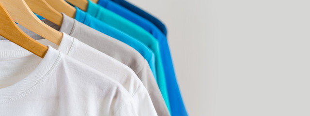 Fototapeta Close up of Colorful t-shirts on hangers, apparel background obraz