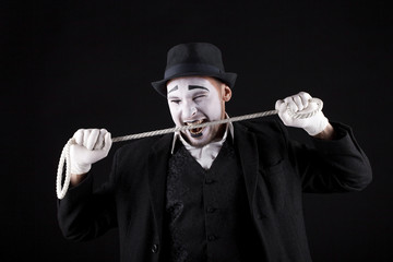 mime shows theatrical emotions on black background