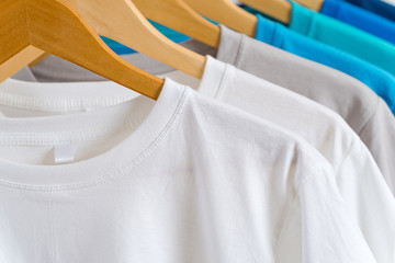 Close up of Colorful t-shirts on hangers, apparel background