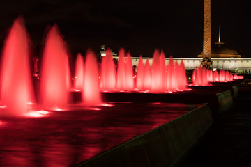 Fountains backlighted by red in Moscow in victory park, Russia