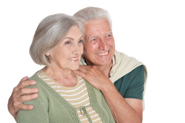 Portrait of happy senior couple embracing on white background