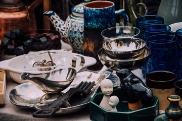 flea market. Vintage stuff. Aesthetics. Fair of old things. Sale of unnecessary things. Garage sale. Weekend Market. Dishes, souvenirs, teapot, cups, spoons, figurines. Antiques. Second hand