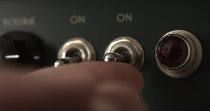 Guitar Player Powering On Tube Valve Vintage Amplifier. Music Related 4K Concept