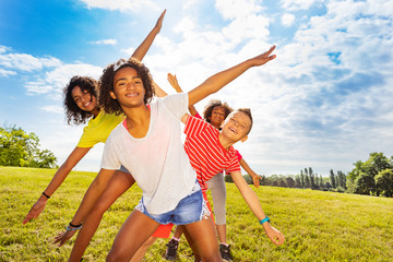 Group of girls and boy smile bending with hands