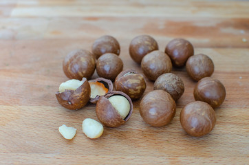 still life of macadamia nuts on a wooden stand
