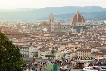 Fototapeta na wymiar Piazzale Michelangelo with Florence skyline. Visitors crowd the terrace overlooking the city.
