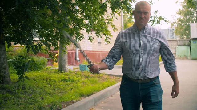 Aggressive offensive man with a chain in his hands. Criminal concept