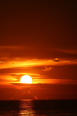 Fototapeta na wymiar sun dawn back on morning sky silhouette cloud on sea