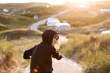 Little girl cycling in campsite, Texel, Holland
