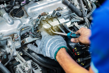 Fototapeta na wymiar man service checking the car engine in a car repair station