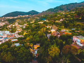 green mountains with orange colored buildingsgreen mountains with orange colored buildings