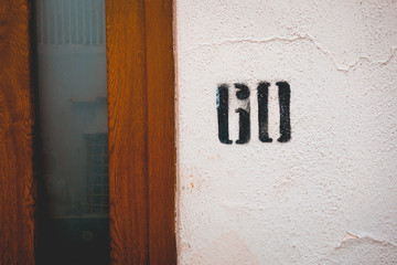 number 60 door sign sprayed at the facadenumber 60 door sign sprayed at the facade