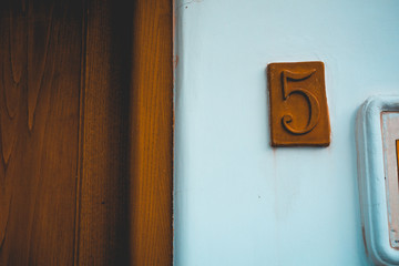 brown number 5 sign on white housebrown number 5 sign on white house