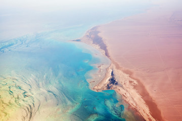 Fototapeta na wymiar Aerial view of turquoise sea coast and a sandy beach