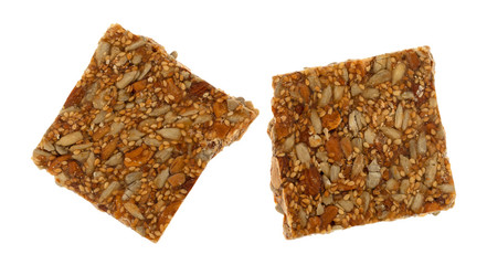 Pieces of honey nut crunch candy on a white background