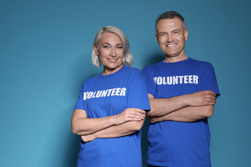 Portrait of volunteers in uniform on blue background