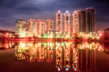 Fototapeta na wymiar Panorama of the night city and lake.