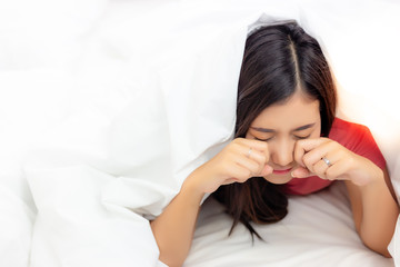 Attractive beautiful student woman do not want go to school or university on Monday morning. Charming beautiful university student looks so lazy for getting on the bed. Lovely girl rub her eyes. space