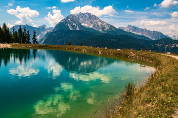 Fototapeta na wymiar Beautiful alpine view with reflections in a lake at the famous Jenner summit near Berchtesgaden, Bavaria, Germany
