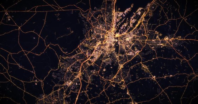 Aerial night view of city of Belfast Ireland UK. Traffic and street light glowing. Camera flying high above, moving closer and rotating from space filming cinematic straight down. 3d animation render