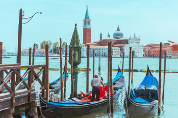 gondolas in dock near pier church of sun giorgio maggiore on background