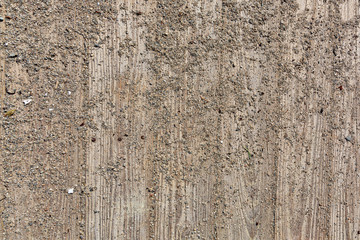 Boards of a boardwalk with sand and gravel.