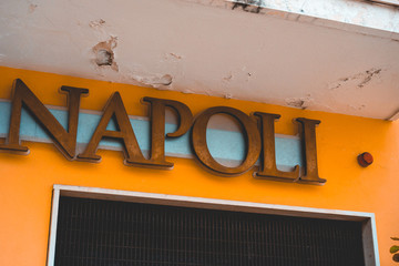 napoli letters on orange buildingnapoli letters on orange building