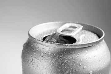 Wet open can on grey background, closeup