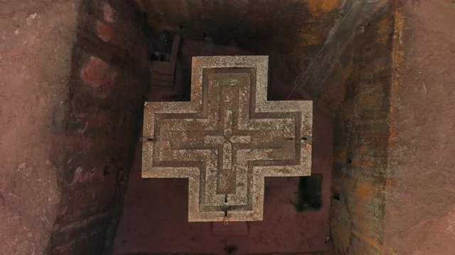 Ascending drone shot of historic Church of Saint George in Lalibela, one of the most sacred places in Christian Orthodox religion in Ethiopia
