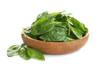 Fresh green healthy baby spinach leaves in wooden bowl isolated on white