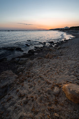 Beach of Sant Tomas on the island of Menorca during sunset. Mediterranean sea in spanish island.
