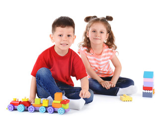 Obraz premium Cute little children playing with toys on white background