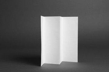 Blank brochure on dark grey background. Mock up for design