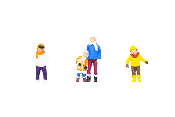 Miniature figurine character as children wearing overcoat and standing in posture isolated on white background.