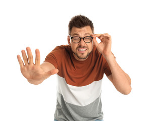 Man with vision problems wearing glasses on white background