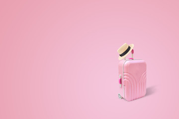 Summer Travel and Vacation Concept : Weave hat put on pink luggage or baggage   in pink background.