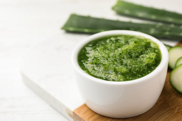 Wooden board with handmade face mask made and ingredients on white table