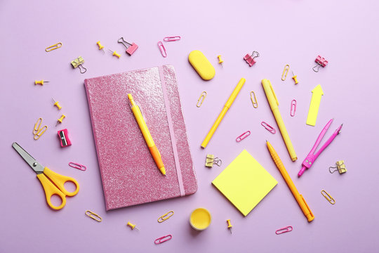 Bright school stationery on lilac background, flat lay