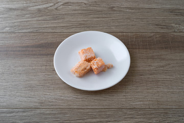 Morsels of salmon on a white plate