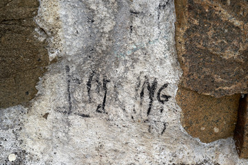 Stone wall background with smooth letters