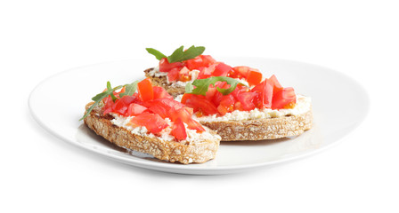 Plate of delicious tomato bruschettas on white background