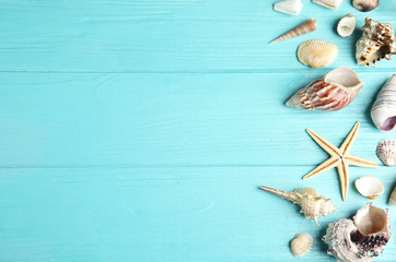Flat lay composition with beautiful starfish and sea shells on blue wooden table, space for text